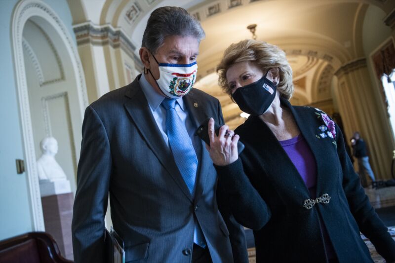 UNITED STATES - FEBRUARY 10: Sens. Joe Manchin, D-W.Va., and Debbie Stabenow, D-Mich., arrive to the Senate for the second day of the impeachment trial of former President Donald Trump in the Capitol on Wednesday, February 10, 2021. (Photo By Tom Williams/CQ-Roll Call, Inc via Getty Images)