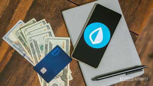 Intuit Mint stock photo of app next to money, cards, and accessories (4)