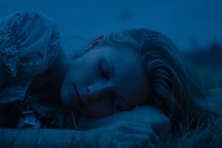 Kirsten Dunst sleeps in a field in The Virgin Suicides.