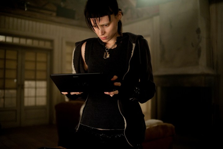 Rooney Mara holds an electronic tablet in The Girl with the Dragon Tattoo.