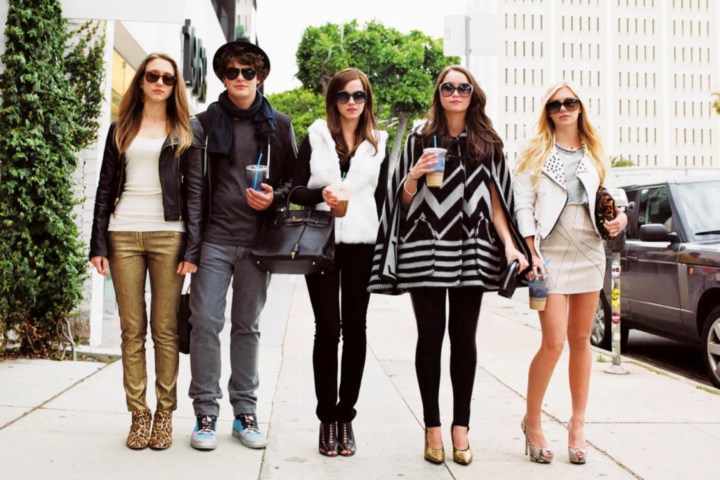 The Bling Ring's cast members wear sunglasses and walk together.