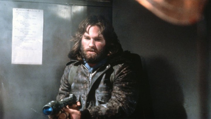 Kurt Russell points a gun in The Thing.