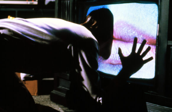 Person pushing their face through a TV screen with human lips on the screen