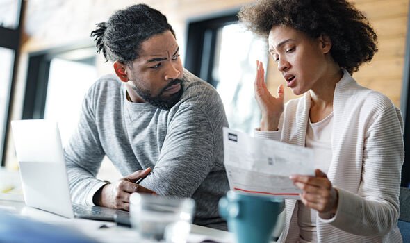 Couple looking concerned at letter