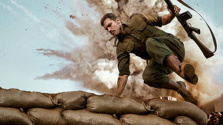 A man hops over a bunker.