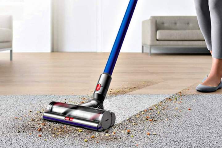 Someone using the Dyson V11 cordless vacuum.