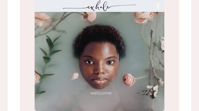 woman's face submerged in bath water surrounded by flowers