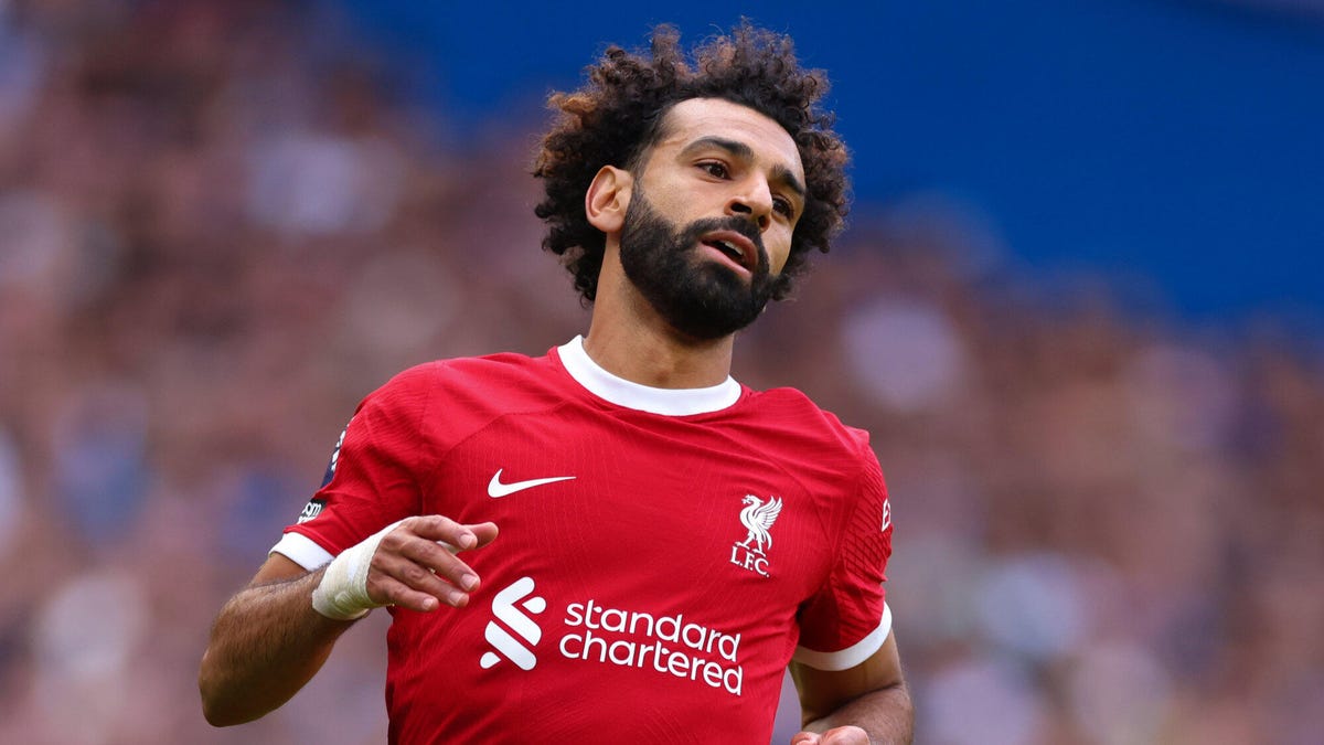 Liverpool forward Mohamed Salah leaning slightly backwards after completing a run.