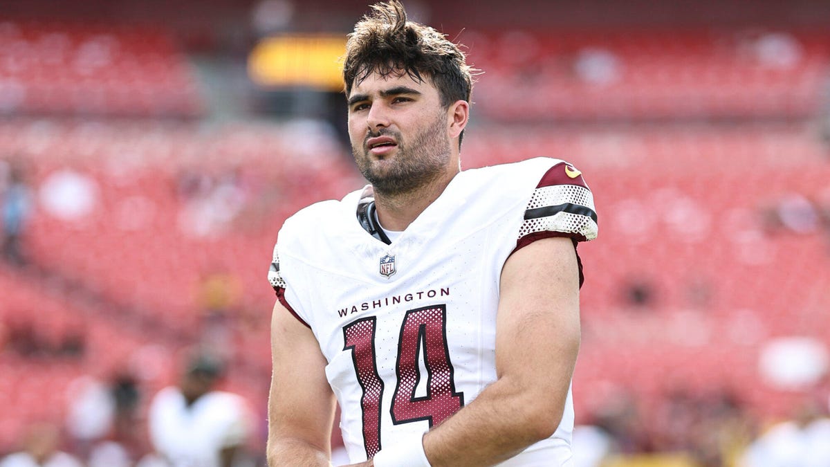 Washington Commanders quarterback looking to his right.