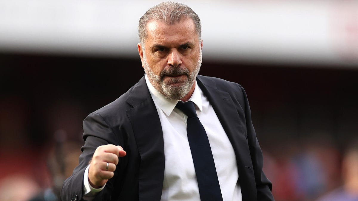 Tottenham Hotspur manager Ange Postecoglou  looking towards the camera, pumping his right fist.