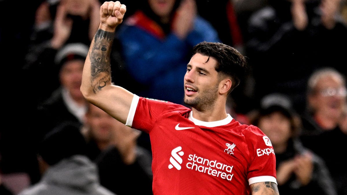 Liverpool midfielder Dominik Szoboszlai celebrating with his right fist raised.