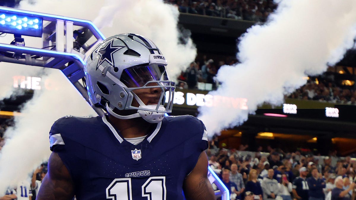 Dallas Cowboys linebacker Micah Parsons looking to his left with plumes of smoke in the background.