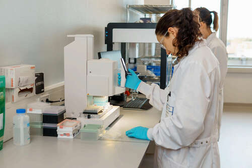 woman in lab coat performing experiments