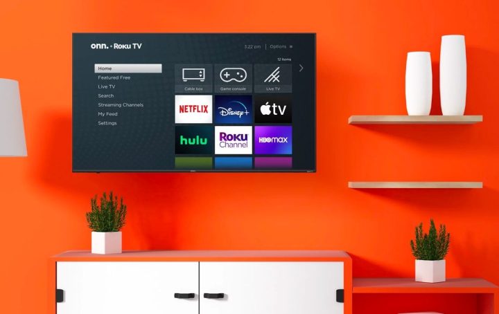 The onn. 70-inch 4K Roku TV hangs on the wall as part of a home theater arrangement.