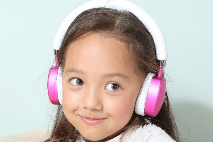 A girl wearing the Puro Sound Labs PuroQuiets headphones.