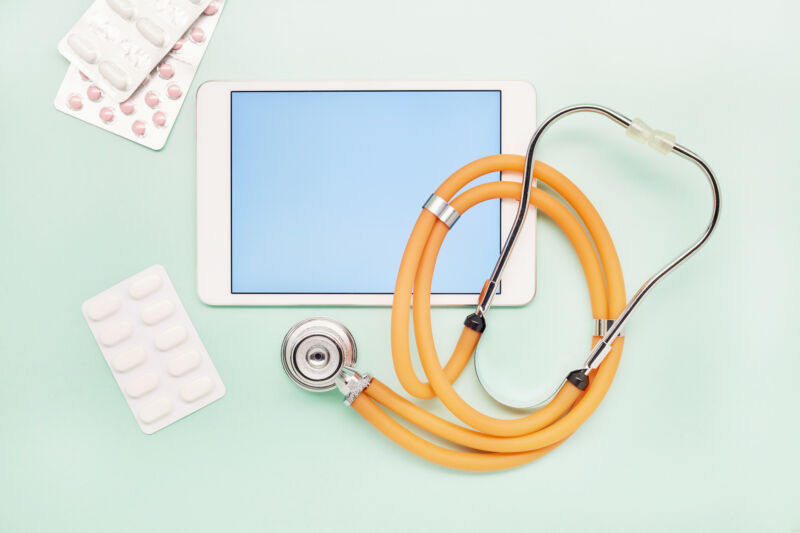 tablet with pills, stethoscope