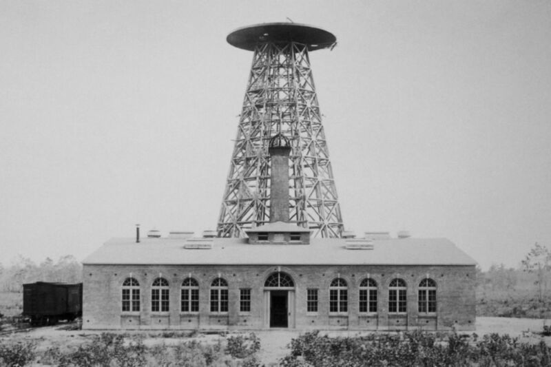 historic photo of low brick building with a steel tower with dome rising from the roof