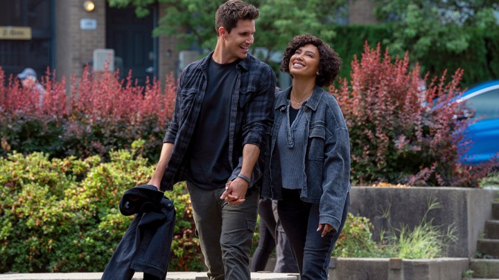 Nathan and Nora walking outside in the real world, smiling and laughing in a scene from Upload.