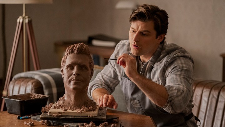 Luke from Upload painting a bust of Nathan's head.