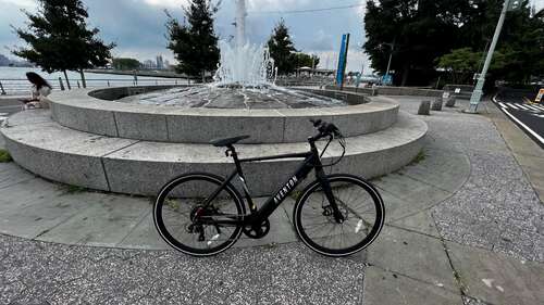 Aventon Soltera 2 in front of a concrete fountain in a park