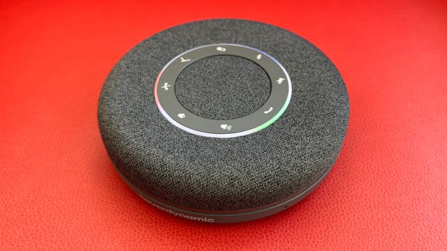 A Beyerdynamic speakerphone against a solid red background.