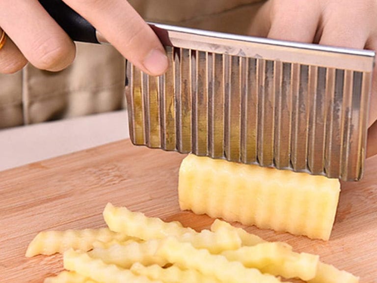 Knife making crinkle cut in potato