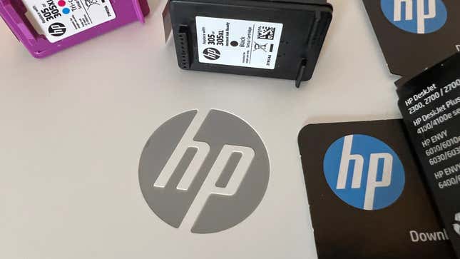 The HP laptop logo next to ink cartridges all sporting HPs logo.