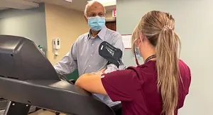 A therapist checks Jagdish Bhatnagar's blood pressure during his supervised exercise therapy (SET) for his peripheral artery disease.