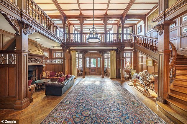 The hallway has a large fireplace surround that reaches from the floor to the floor of the gallery