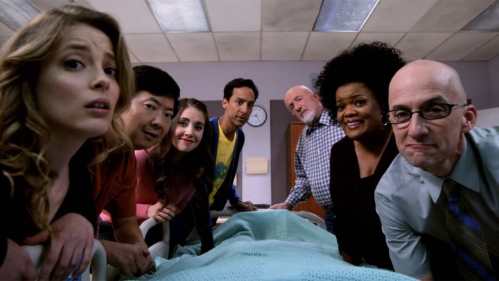 The cast of Community gathers round Jeff's hospital bed.