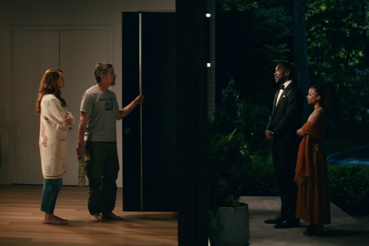 Julia Roberts, Ethan Hawke, Mahershala Ali, and Myha'la stand on opposite sides of a door in Leave the World Behind.