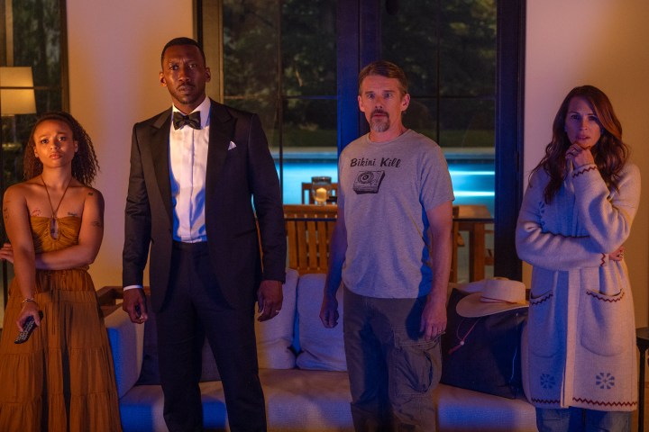 Myha'la, Mahershala Ali, Ethan Hawke, and Julia Roberts look at a TV screen together in Leave the World Behind.