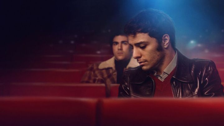 Damiano Gavino and Andrea Di Luigi as Enea and Pietro sitting in an empty theater in the film Nuevo Olimpo.