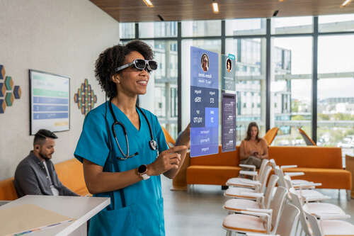 Nurse Reading Charts With AR Glasses Before Calling Patient