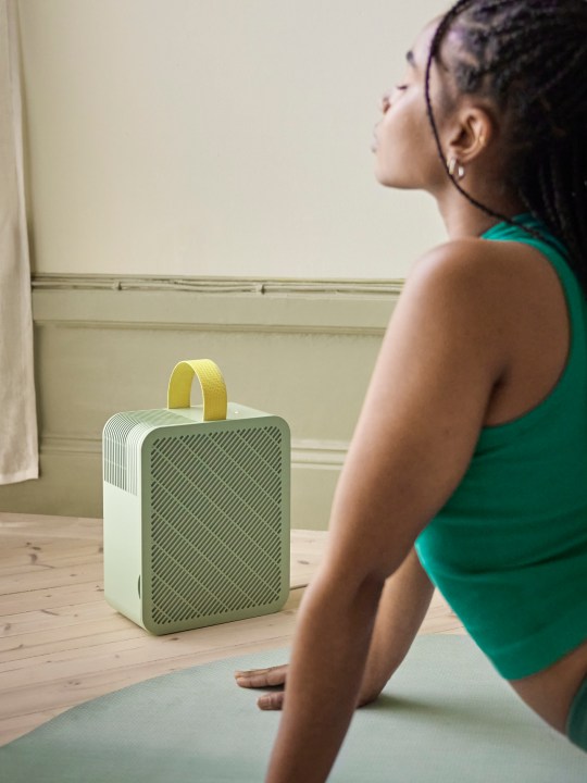 A person stretching near the Dajlien Air Purifier.