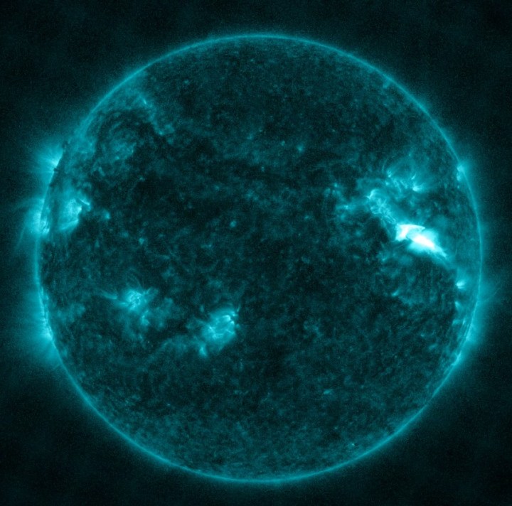 NASA’s Solar Dynamics Observatory captured this image of a solar flare – as seen in the bright flash in the upper right – on Dec. 14. The image shows a subset of extreme ultraviolet light that highlights the extremely hot material in flares, and which is colorized in teal.