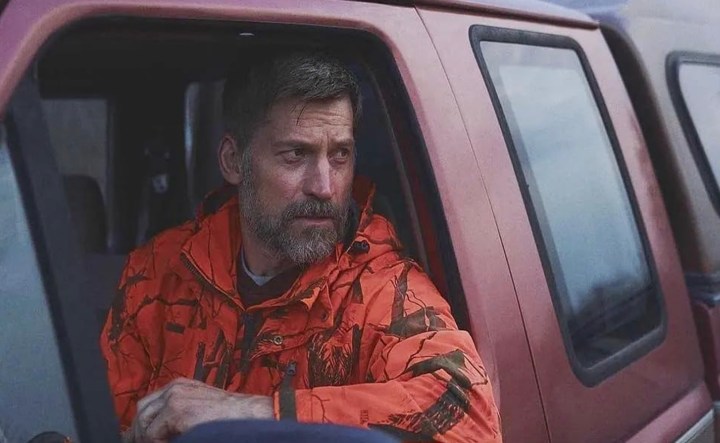 A man sits in his truck and stares.