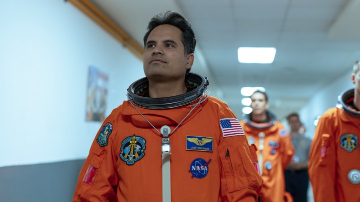 Michael Peña as José in a spacesuit walking down a hall in the movie A Million Miles Away.