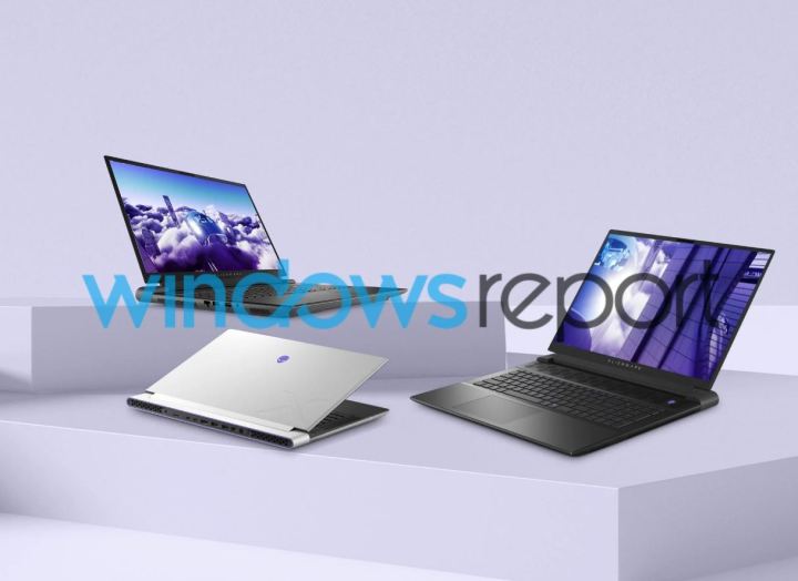 Three new Alienware laptops on a table, in front of a grey background.