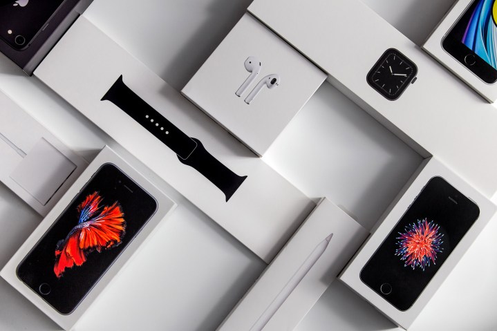 Boxes for an Apple Watch, iPhones, and Airpods sit on a desk.