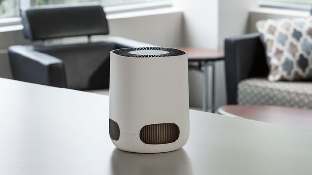 A small white air purifier in an office