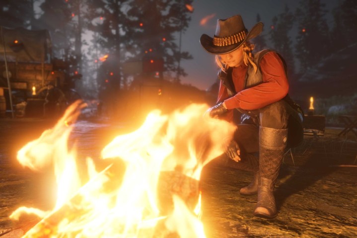 A cowboy sitting by a fire.