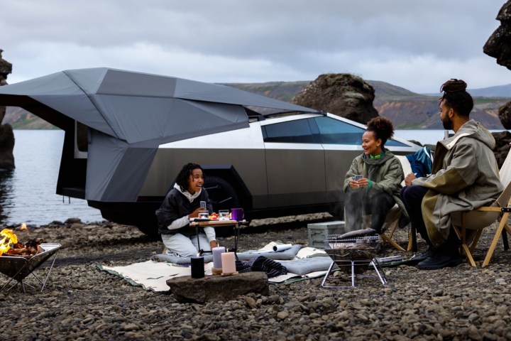 A family camps in the back of a Tesla Cybertruck.