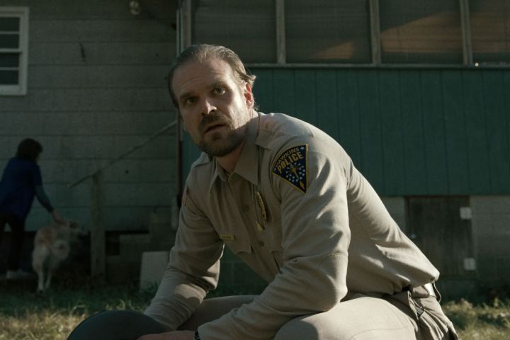 David Harbour sits and stares in Stranger Things.