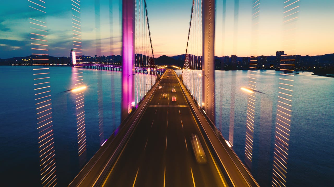 bridge and cars crossing a bridge at sunrise