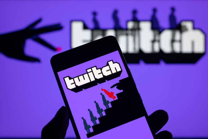 The Twitch logo is displayed on a smartphone