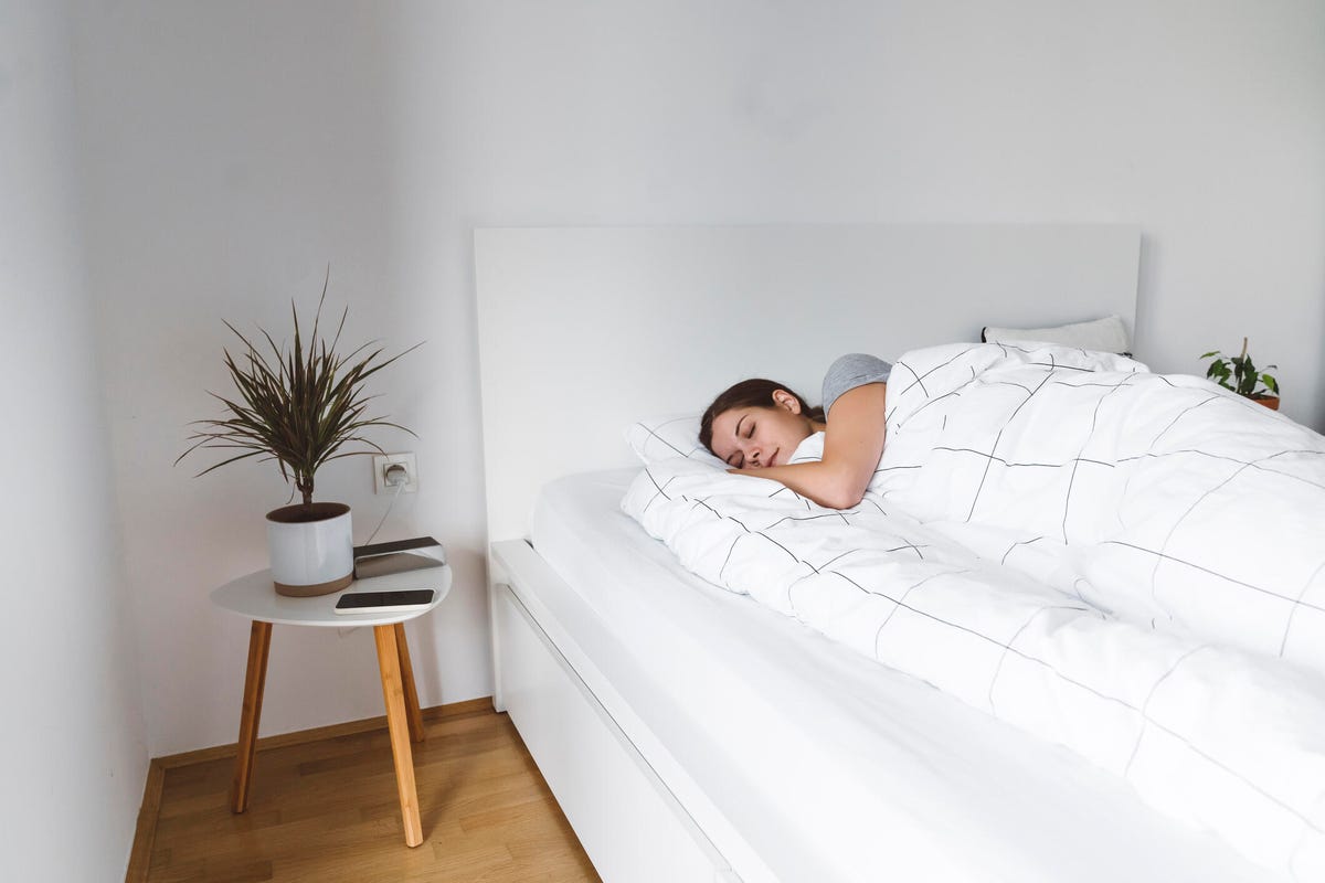 Woman side sleeping on a twin size bed.