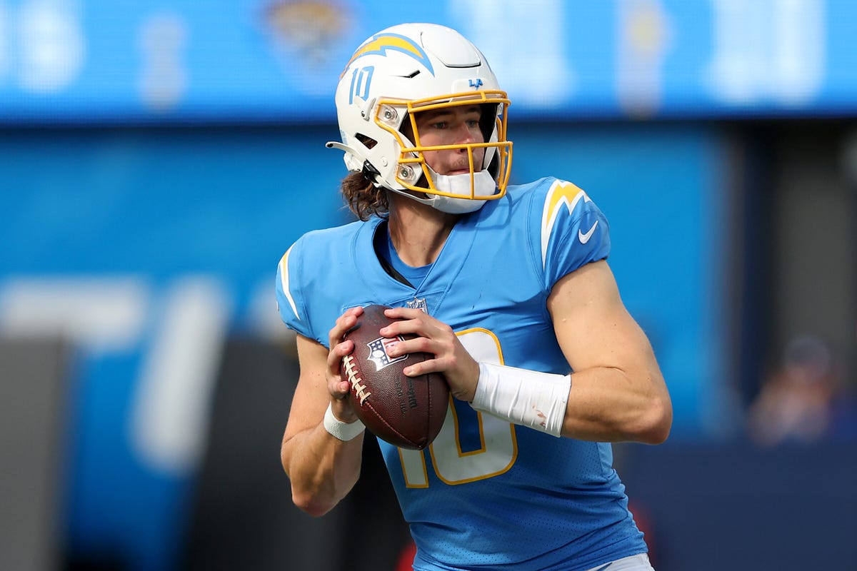 Justin Herbert of the Los Angeles Chargers rolls out to pass