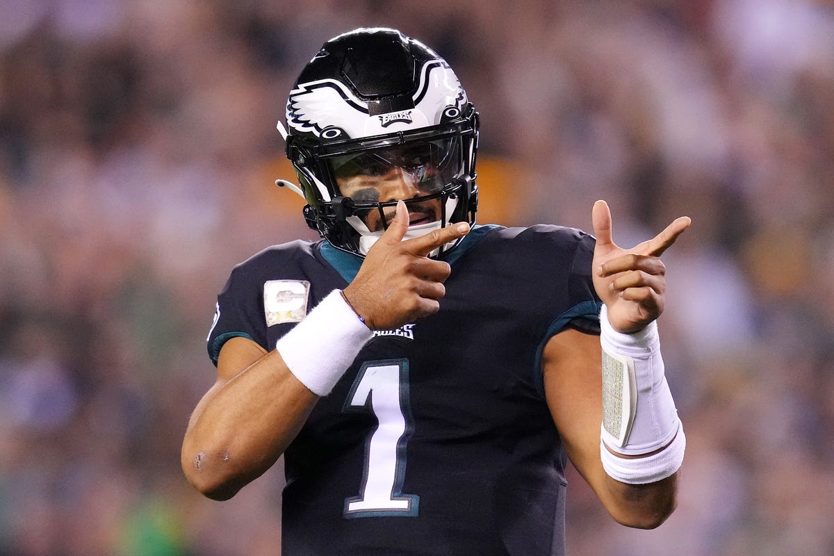 Quarterback Jalen Hurts of the Philadelphia Eagles does a finger-guns gesture