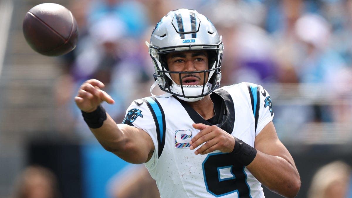 Carolina Panthers quarterback throwing a ball towards the camera.